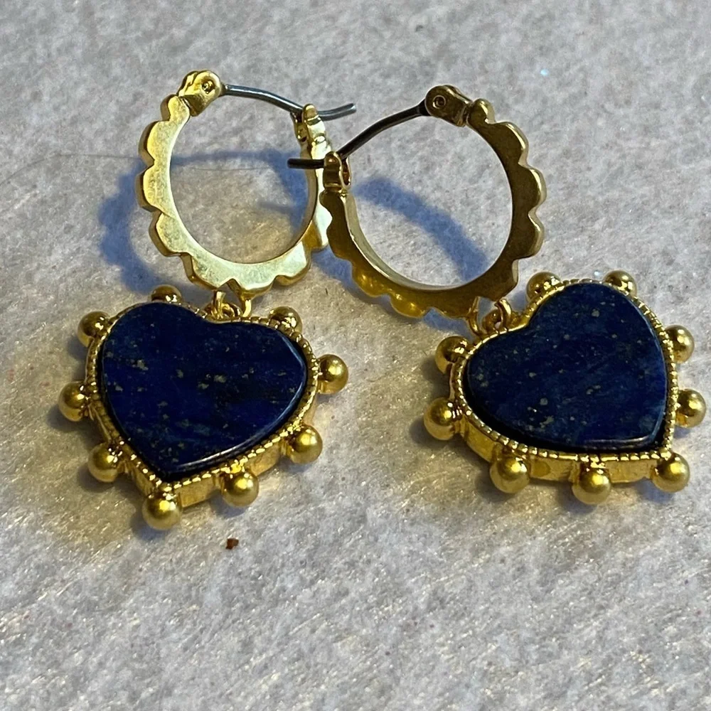 Tory Burch blue lapis heart drops hanging from huggie hoops.
